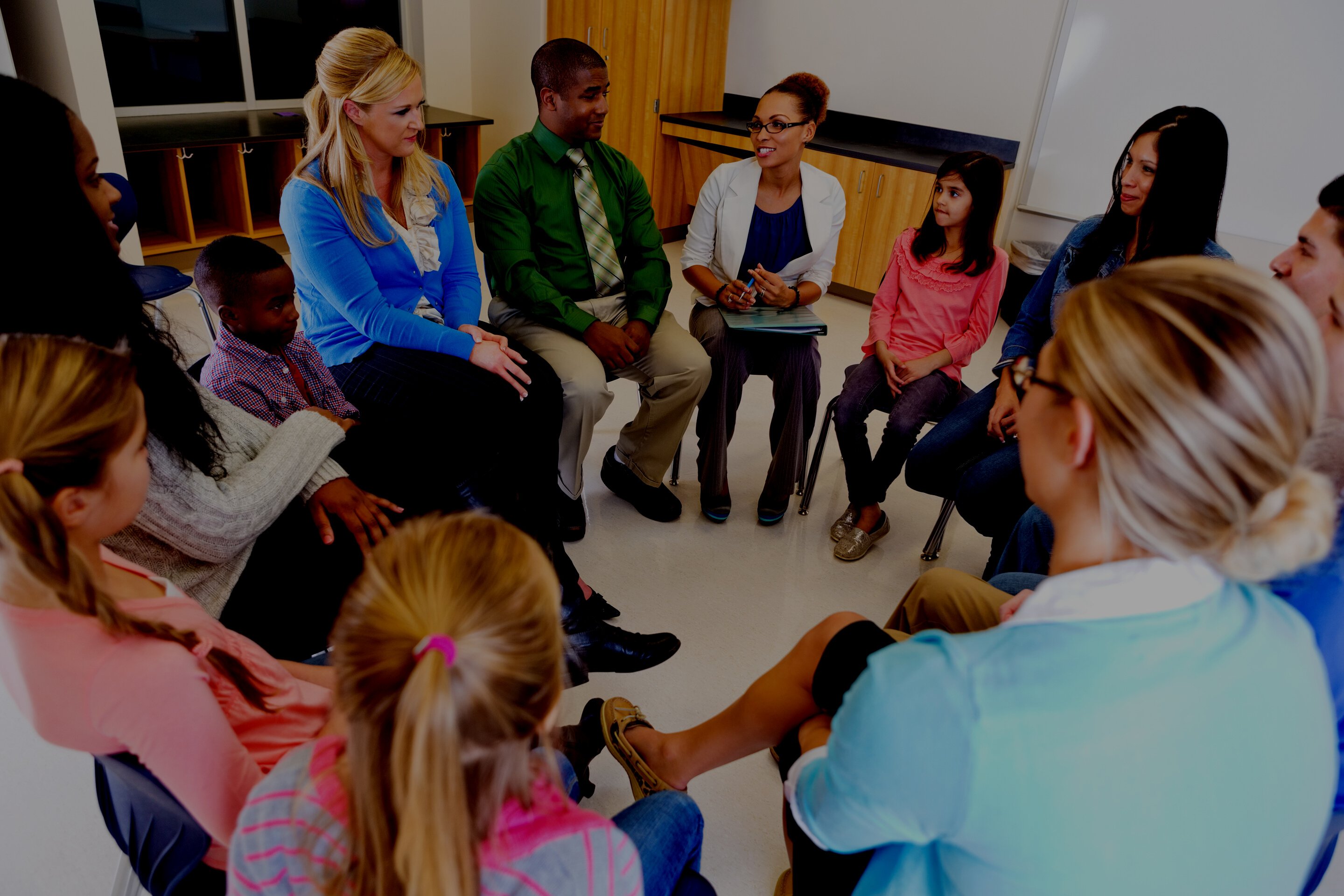 Elementary school discussion meeting with teachers parents and students